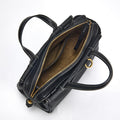 Black Mini Yore Duffle Bag: tan interior, gold zipper, white stitching. Compact leather travel bag.