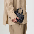 Mini Yore Duffle Bag in Onyx, crafted from vegetable-tanned leather with adjustable strap and stainless steel hardware.