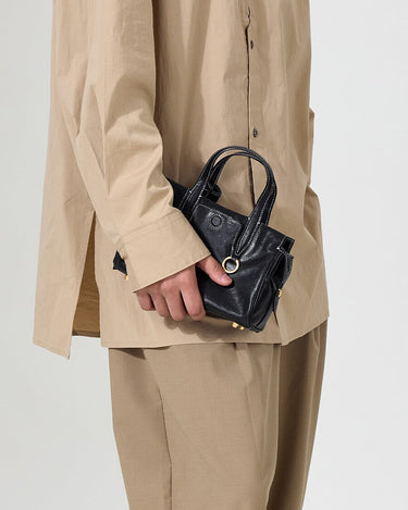 Mini Yore Duffle Bag in Onyx, crafted from vegetable-tanned leather with adjustable strap and stainless steel hardware.