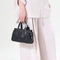 Mini Yore Duffle Bag in Onyx, vegetable-tanned leather with white stitching, ideal for travel and everyday use.