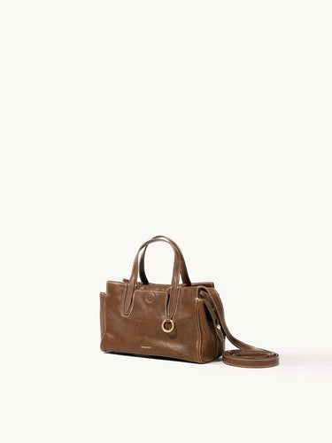 Mini Yore Duffle Bag in Sandal leather, vegetable-tanned, with white stitching and gold hardware.