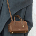 Mini Yore Duffle Bag in Sandal color, featuring vegetable-tanned leather, gold hardware, and white stitching.