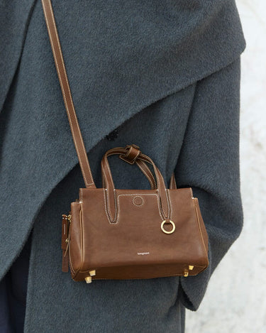 Mini Yore Duffle Bag in Sandal color, featuring vegetable-tanned leather, gold hardware, and white stitching.