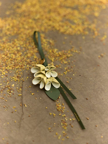 Osmanthus Charm leather accessory designed as a flower, crafted with handmade techniques.