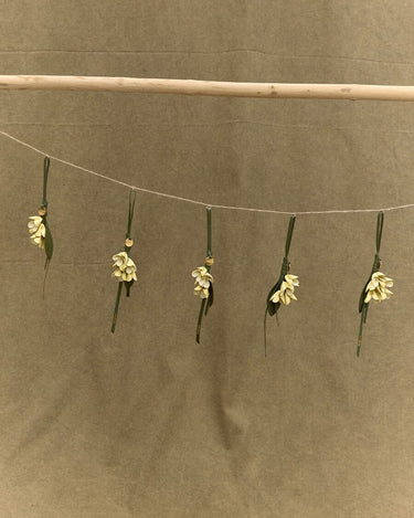 Osmanthus Charm in full-grain leather, detailed with handmade floral design and golden bead.