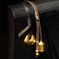 Prayer Wheel Charm: Sandal & Onyx leather straps with gold pendants. "Songmont" logo embossed.