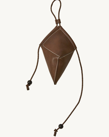 Brown leather Prism Airpods case with white stitching and braided strap with sandalwood beads.