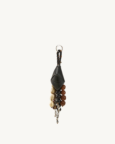 Prism Seed Charm keychain with black leather accent and a cluster of natural seed beads in various earthy tones.