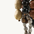 Prism Seed Charm with natural bodhi seeds in onyx and sandal colors