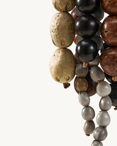 Prism Seed Charm with natural bodhi seeds in onyx and sandal colors