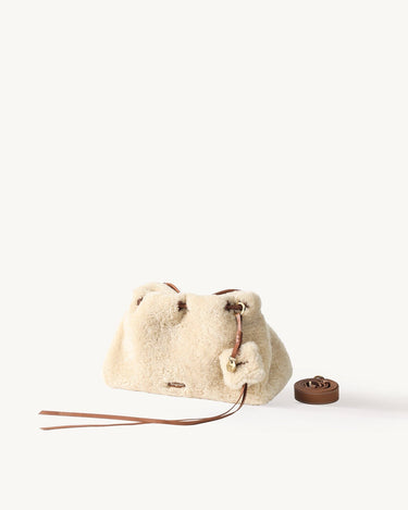 Shearling Gather Clutch Set in amber featuring plush shearling and leather details, with a rolled strap.