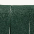 Small Drippy Roof Bag in textured dark green full-grain leather with white stitching detail.
