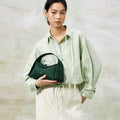 Small Drippy Roof Bag in deep green full-grain leather with microfiber lining and stainless steel hardware.
