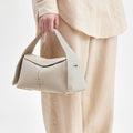 Small Drippy Roof Bag in Ivory, made from full-grain leather with a structured shape and a minimalist design.