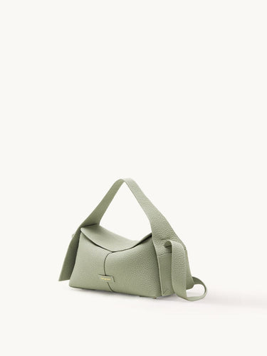 Small green pebbled leather crossbody bag with adjustable strap and gold embossed logo.