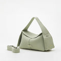 Small green pebble-grain leather handbag with top handle and detachable strap, featuring gold 'Songmont' logo.