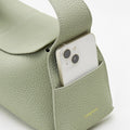 Light sage green full-grain leather handbag with phone pocket and 'Songmont' gold logo