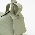Small Drippy Roof Bag in light green full-grain leather with embossed 'Songmont' logo.
