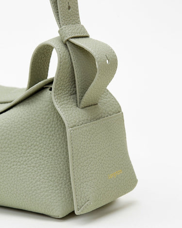 Small Drippy Roof Bag in light green full-grain leather with embossed 'Songmont' logo.