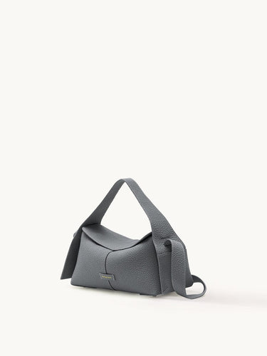 Small grey full-grain leather crossbody bag with microfiber lining and stainless steel hardware.