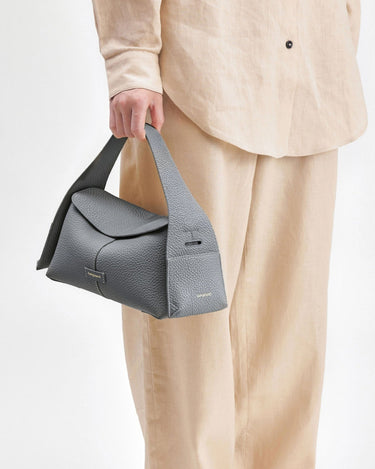 Grey full-grain leather Small Drippy Roof Bag with tan linen outfit