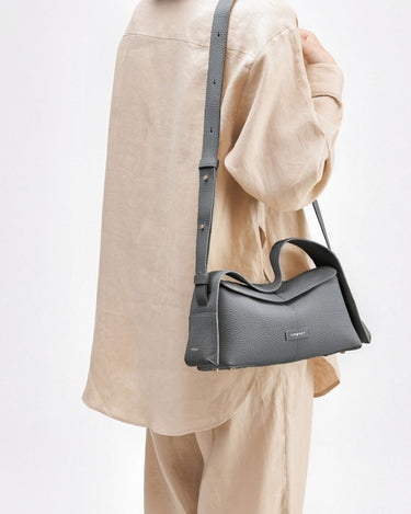 Small grey pebbled full-grain leather crossbody bag with adjustable strap