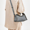 Grey full-grain leather crossbody bag with gold hardware, "Songmont" embossed on front flap.