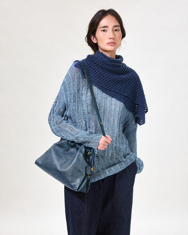 Navy Small Gather Bag Set worn by model with distressed blue sweater and dark jeans.