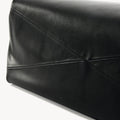 Close-up of black leather Small Gather Bag Set showing geometric stitching and textured finish.