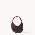 Small Luna Bag in burgundy full-grain leather with gold-tone hardware and adjustable strap.