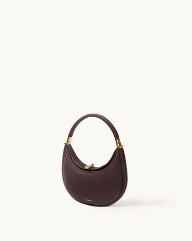 Small Luna Bag in burgundy full-grain leather with gold-tone hardware and adjustable strap.