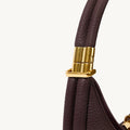 Small Luna Bag in burgundy full-grain leather with gold-tone hardware detail.