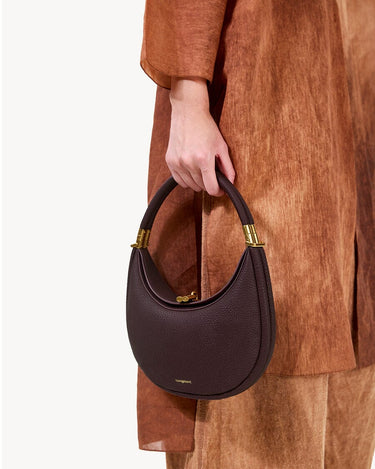 Small Luna Bag in burgundy full-grain leather with gold hardware and clasp detail.