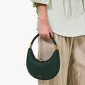 Emerald green pebble-grain Small Luna Bag with gold hardware and clasp. Handheld with rounded strap.