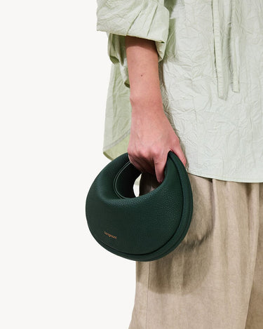 Small Luna Bag in emerald green pebbled leather, a curved handbag by Songmont.