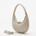 Small Luna Bag in ivory full-grain leather with gold hardware and adjustable strap. Versatile for shoulder or crossbody wear.
