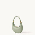 Small Luna Bag in Jade green leather with gold hardware, featuring a crescent shape and top handle.