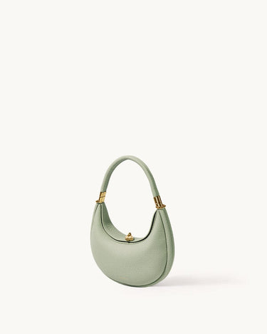 Small Luna Bag in Jade green leather with gold hardware, featuring a crescent shape and top handle.