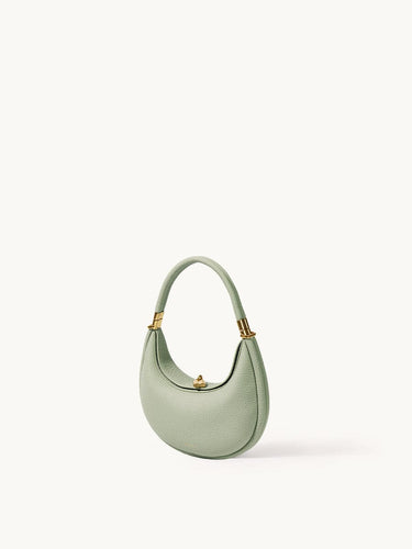 Small Luna Bag in Jade green leather with gold hardware, featuring a crescent shape and top handle.