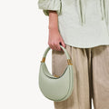 Small Luna Bag in Jade green pebble-grain leather with gold hardware details.