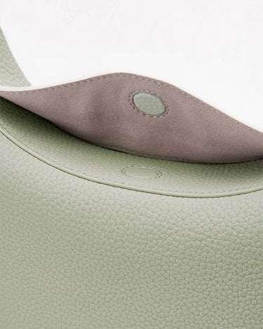 Close-up of the magnetic closure on the Small Luna Bag in Jade, showcasing textured full-grain leather.