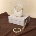 Small Luna bag in ivory full-grain leather with braided pet leash in cream apricot.
