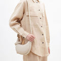 Ivory full-grain leather Small Luna bag with cream apricot cotton and leather leash.