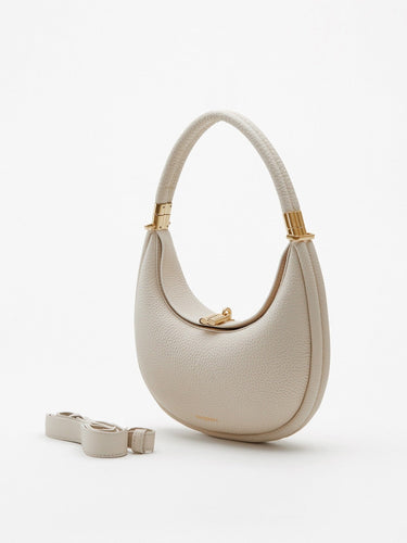 Small Luna bag in ivory full-grain leather with gold hardware and detachable strap.