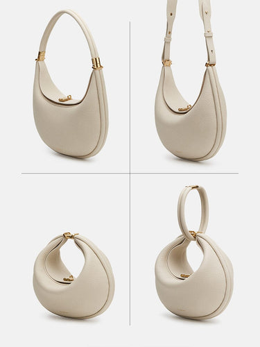 Small Luna bag in ivory full-grain leather with gold-tone hardware. Features a curved silhouette and top handle.