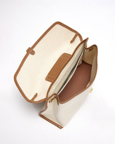 Open canvas Small Shan Satchel Bag with tan leather trim and interior pockets.