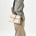 Small Shan Satchel Bag in Canvas with leather trim, featuring a gold buckle closure. Perfect for everyday wear.