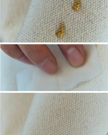 Small Shan Satchel Bag canvas demonstrating water-resistant properties with liquid droplets beading up and being wiped away.