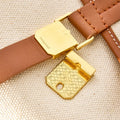 Small Shan Satchel Bag: gold clasp with 'Songmont' logo on leather strap, gold patterned buckle.