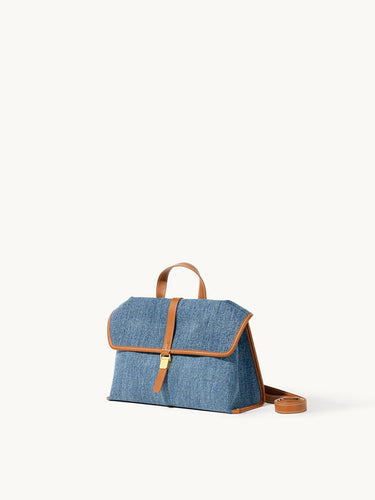 Small Shan Satchel Bag in denim with tan leather trim and strap.
